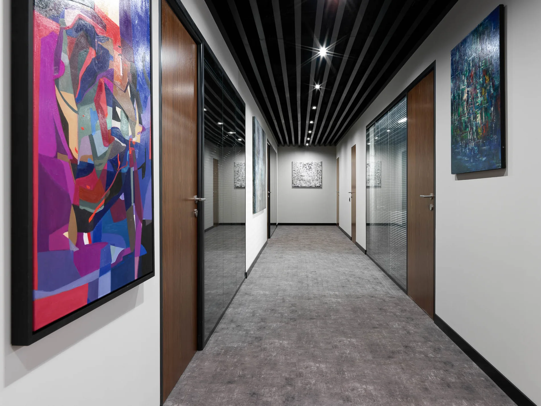 Corredor de una oficina en Moscú, Rusia, articulado por pinturas abstractas de colores intensos.